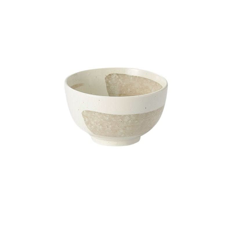 Japanese Minoyaki bowl with speckled beige and white glaze, on white background.